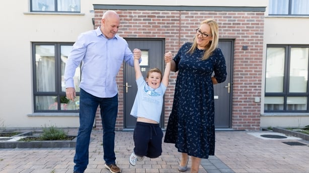 A family in front of their home