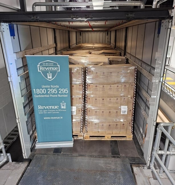 boxes and a revenue sign in a trailer