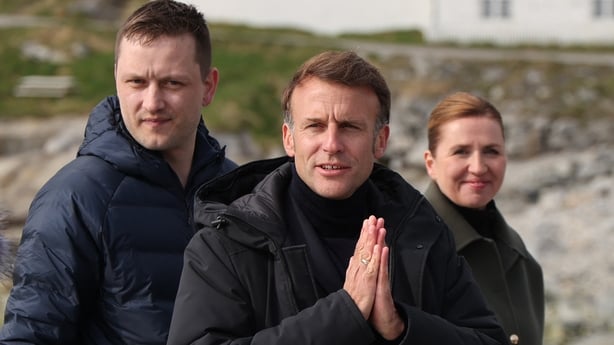 French President Emmanuel Macron gestures next to Greenland's Prime Minister Jens-Frederik Nielsen and Danish Prime Minister Mette Frederiksen at the end of a joint press conference in Nuuk, Greenland