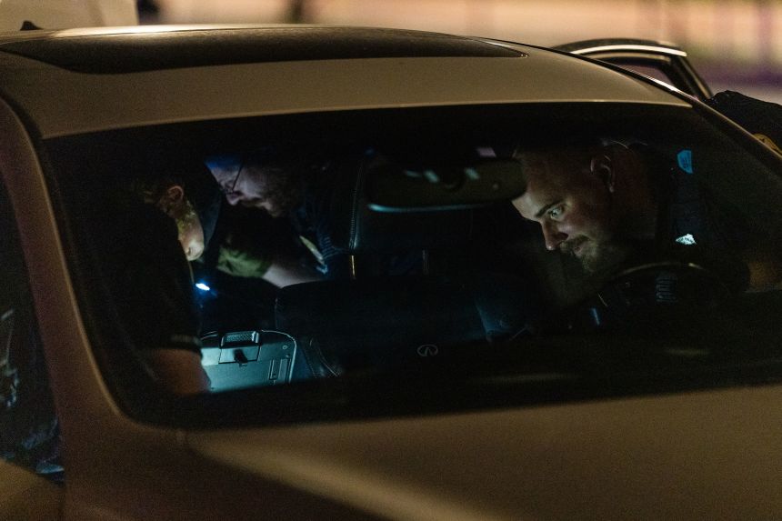 Metropolitan Police Department officers and Homeland Security Investigations special agents search a vehicle on North Capitol Street NE in Washington, DC, on Thursday.