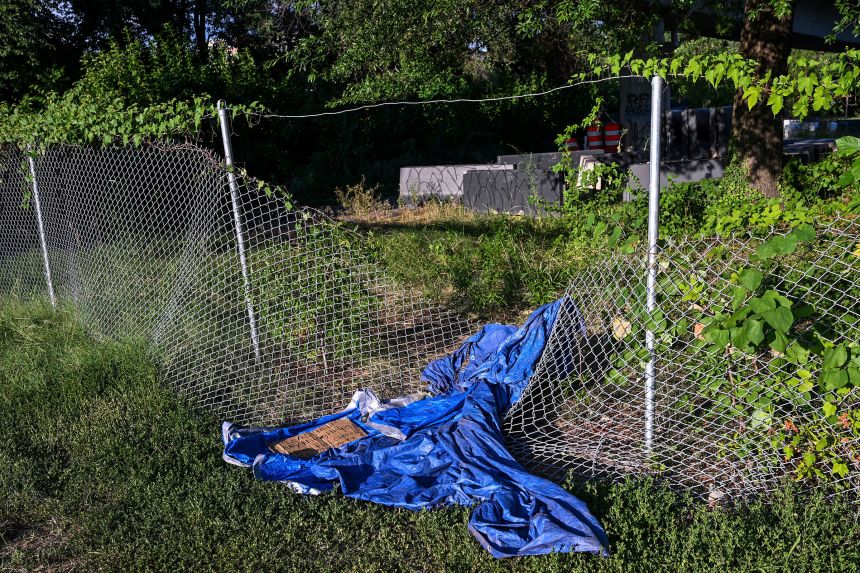 A handmade sign is laid near a makeshift shelter on a sidewalk in Washington, DC, on Monday.