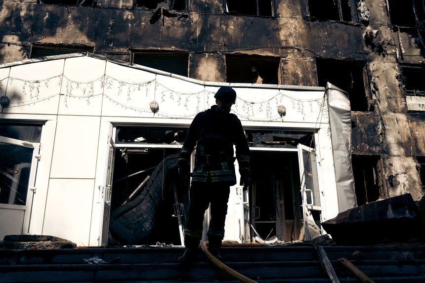 A rescue worker in front of a damaged building at Sumy State University in Sumy, Ukraine, following a Russian airstrike on August 18.