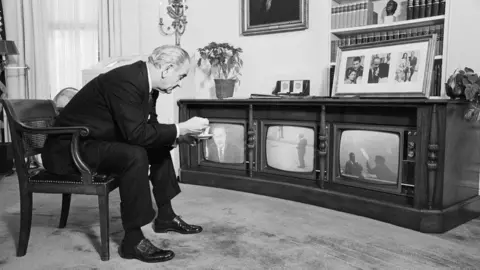 Getty Images Lyndon Johnson watching the Apollo 8 mission on three televisions.