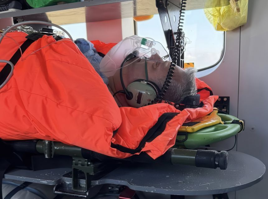 Cllr Brian Carr being taken to hospital by SAR 118. Photo: North West newspix