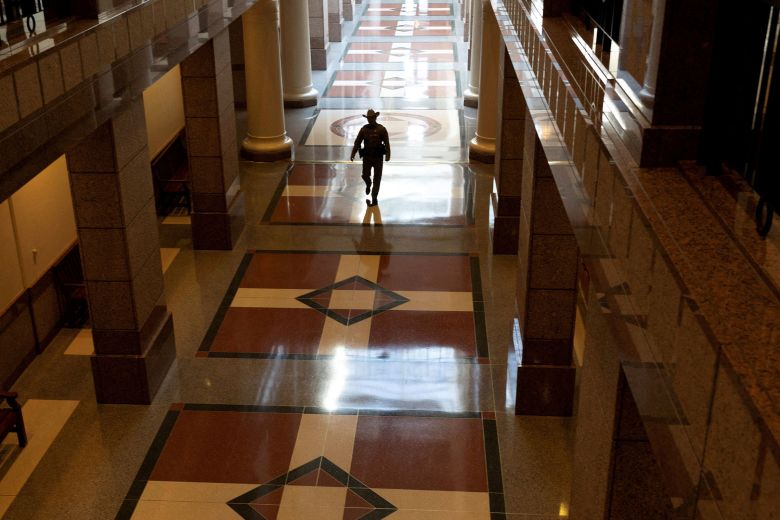 A state trooper walks through the Texas State Capitol on August 8.