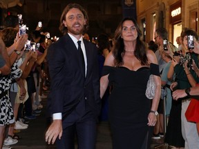 Tommy Fleetwood and wife Clare Fleetwood walk through fans at the Spanish Steps prior to the 2023 Ryder Cup in Rome, Italy.