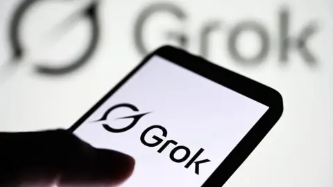 Getty Images Grok logo displayed on a smartphone, with it's logo shown on a blurred, larger backdrop behind it. 