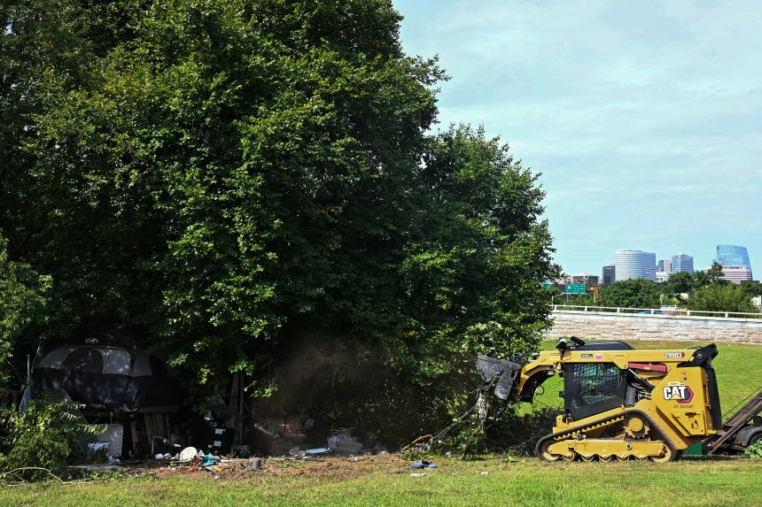DC city workers dismantle tents and remove personal belongings during a sweep of a homeless encampment in the Foggy Bottom neighborhood of Washington, DC, on Thursday.