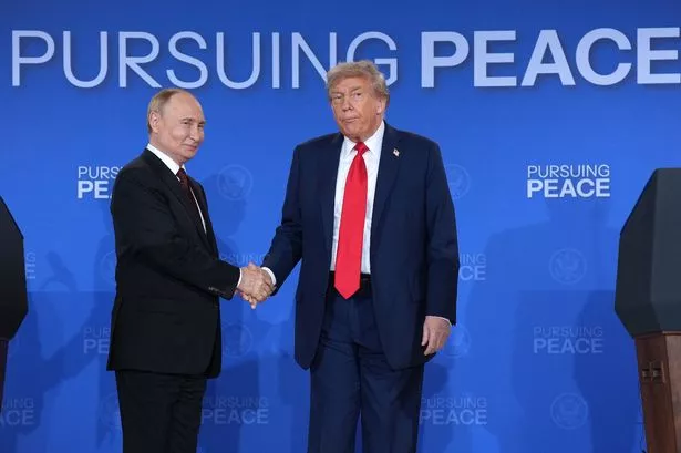 U.S. President Donald Trump (R) and Russian President Vladimir Putin shake hands at the end of a press conference at Joint Base Elmendorf-Richardson on August 15, 2025 in Anchorage, Alaska. 