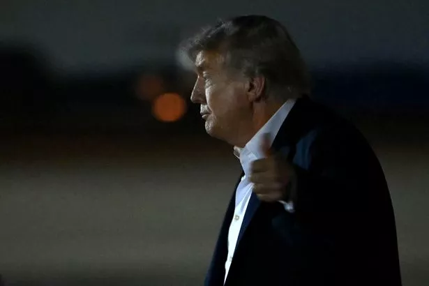 US President Donald Trump gives a thumbs up after landing at Joint Base Andrews in Maryland, on August 15, 2025. 