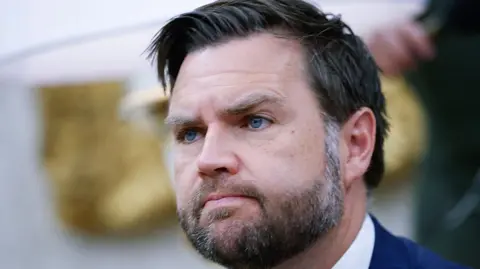 Getty Images JD Vance, a  bearded man with dark hair and blue eyes