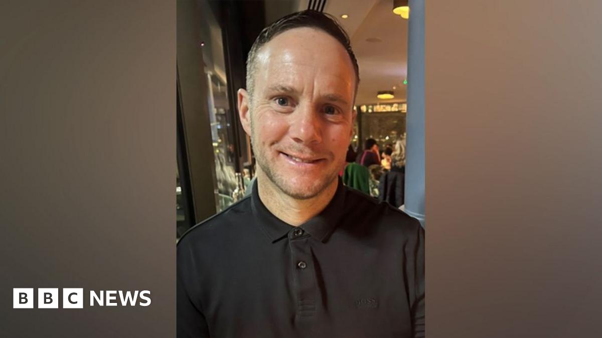 Lee Claydon smiling and wearing a black shirt