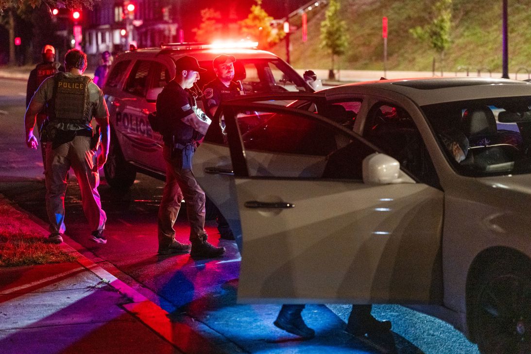 Metropolitan Police Department officers and Homeland Security Investigations special agents search a vehicle on Thursday.