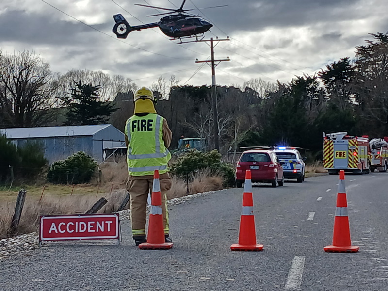 Emergency services attend the scene of the crash on Waitahuna Gully Rd. Photo: Nick Brook