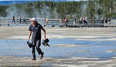 A tourist wearing flip-flops steps onto a fragile bacterial mat at Yellowstone's Grand Prismatic Spring to retrieve hats, sparking outrage among park visitors