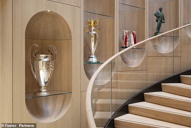 Pictured: replicas of some of the club's trophies adorn one of the staircases at the facility