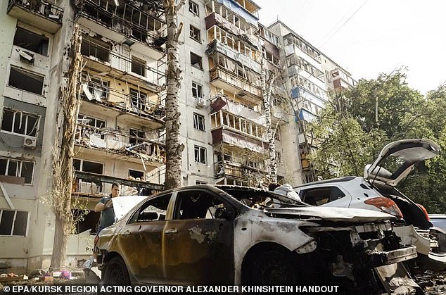 Damaged cars and buildings after a reported Ukrainian strike in Kursk, Russia, on Friday