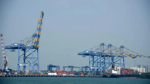 Kochi docks and shipping container port in Kochi (also known as Cochin), India. Kochi, is a major port city on the south west coast of India by the Laccadive Sea and is part of the district of Ernakulam in the state of Kerala. 14 Jan 2015, 05:30