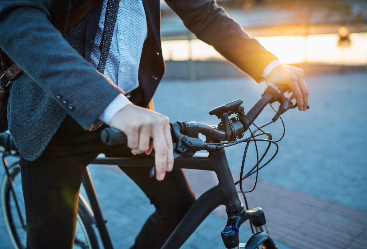 Person in a suit on a bicycle