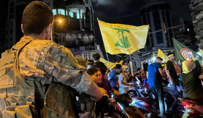 Soldiers deploy as supporters of Lebanon's militant group protest government's endorsement of a plan to disarm it in Beirut. 