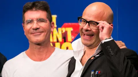 Getty Images Simon Cowell and Harry Hill attend a photocall to launch "I Can't Sing - The X Factor Musical" at RADA on September 2, 2013 in London, England