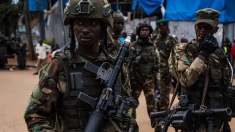 Getty M23 rebels guard a unit of surrendering Congolese police officers who will be recruited into the rebel group on February 22, 2025 in Bukavu, Democratic Republic of Congo.
