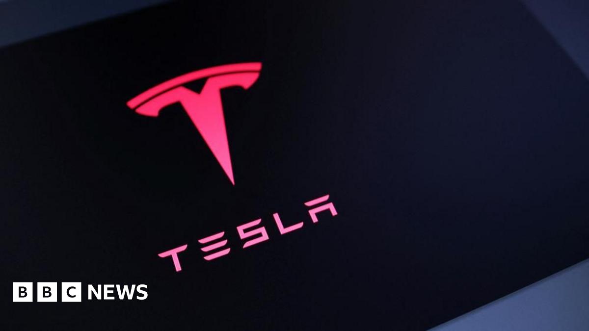 A Tesla logo is red with a black background