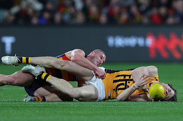 Hawthorn’s Will Day is tackled by Sam Berry during their game at Adelaide Oval.