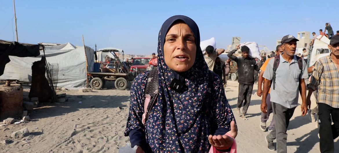 Asma Masoud, a displaced woman from northern Gaza, returning from a search for food.
