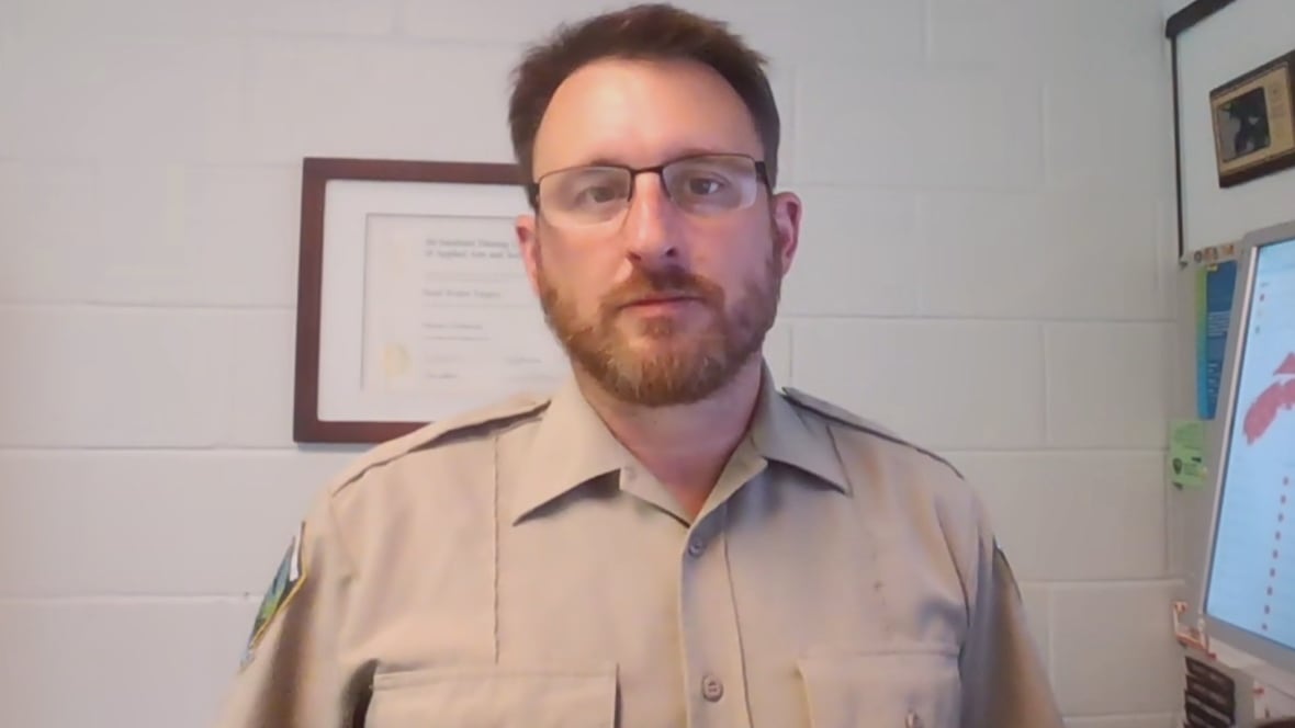Man with glasses wears beige shirt