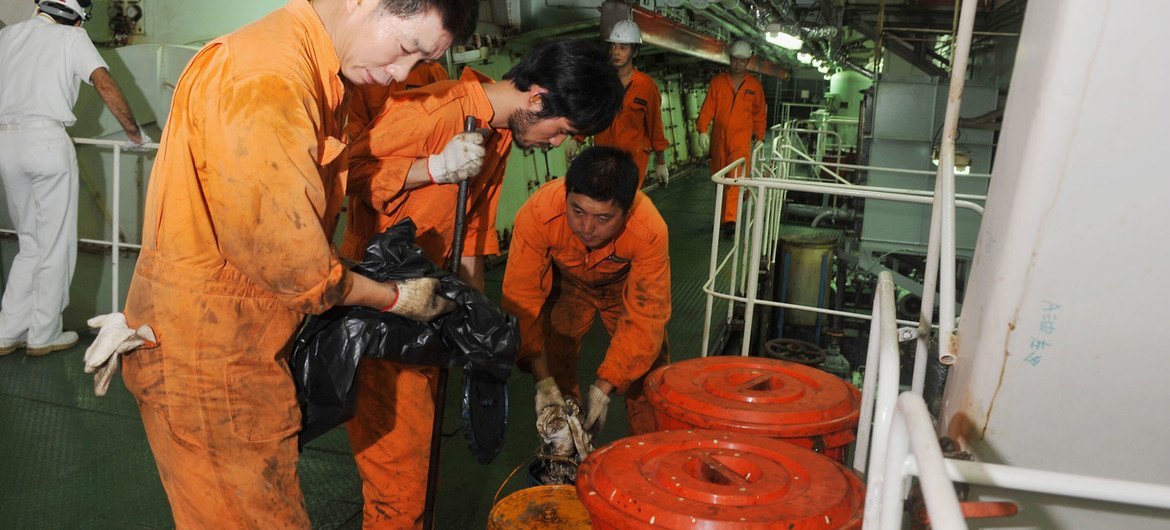 Seafarers work in the engine room of a Chinese registered ship in the Port of Genoa in Italy. (file)