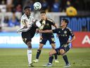 Mark-Anthony Kaye  of the San Jose Earthquakes attempts to settle the ball against Andrés Cubas of the Vancouver Whitecaps in San Jose, California Aug. 9, 2025.