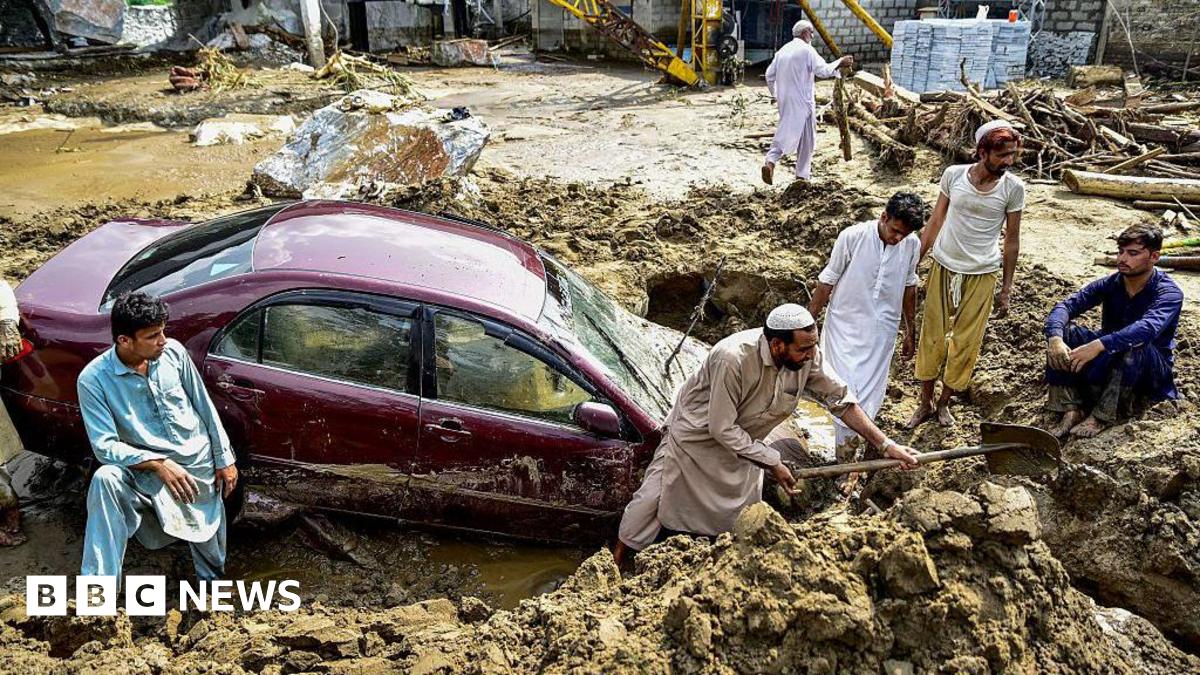 People struggle to retrieve a car from mud and debris after flash floods in the Buner district of the monsoon-hit northern Pakistani province of Khyber Pakhtunkhwa, on 16 August 2025.