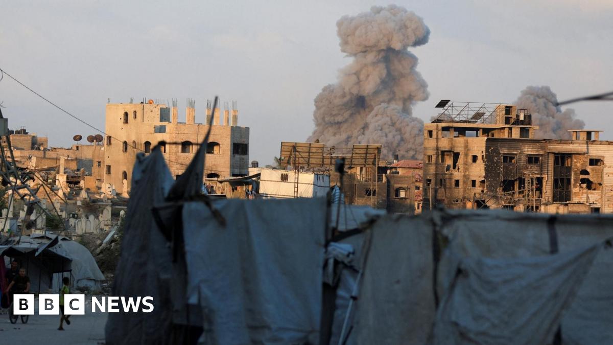 Smoke rises above buildings that are partially constructed and others that are burnt out and damaged, following an Israeli strike in Gaza City (21 August 2025)