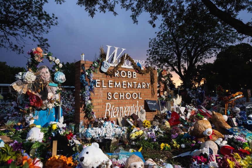 The sun sets behind the memorial for the victims of the massacre at Robb Elementary School in Uvalde, Texas, in August 2022.