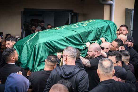 Mourners surround Sam Abdulrahim’s casket at the Alawi Islamic Association in Epping.