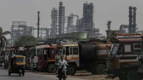 Bloomberg via Getty Images Oil tanker trucks outside an oil refinery operated by Bharat Petroleum Corp. Ltd., in Mumbai, India, on Friday, April 4, 2025