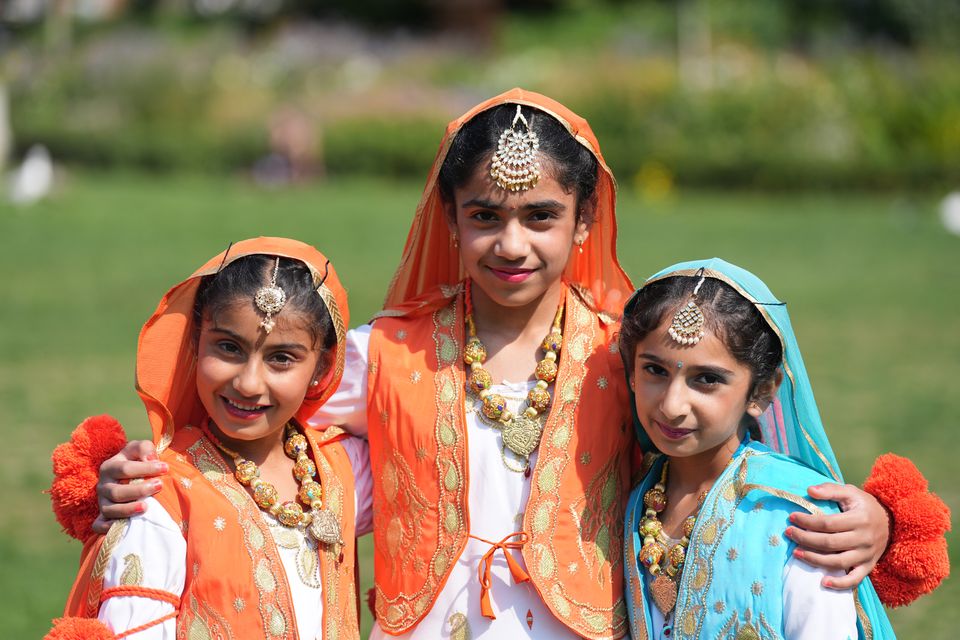 From left, Areet Kaur Chandi, seven, Japleen Kaur, 10, and Preety Singh, eight, join the festivities for India Day in Dublin (Niall Carson/PA)