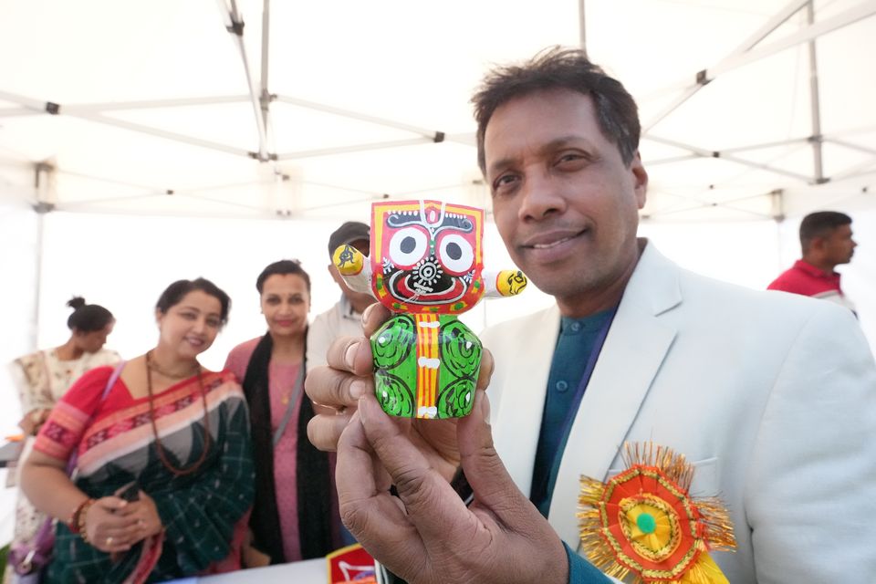 Event organizer Sanjeeb Barik with a statue of the Indian deity Jagannath as people attend the India Day Festival at Merrion Square Park, Dublin (Niall Carson/PA)
