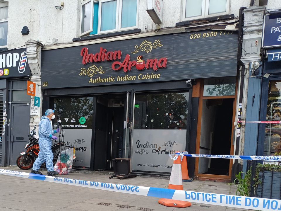 A forensic investigator at a restaurant in Ilford, east London (Helen William/PA)
