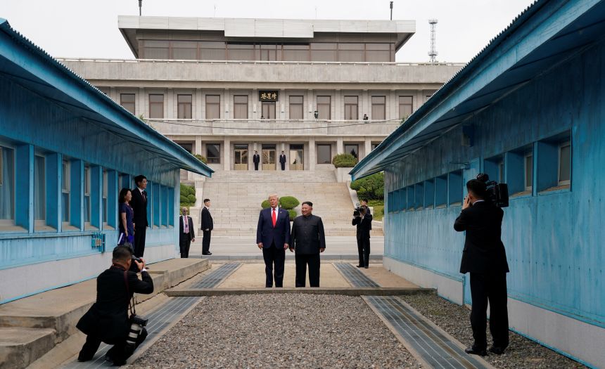 US President Donald Trump and North Korean leader Kim Jong Un stand at the demarcation line in the demilitarized zone separating the two Koreas, in Panmunjom, South Korea, on June 30, 2019.