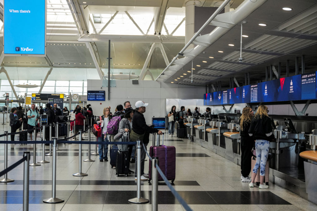 FILE PHOTO: Travellers are seen at the Delta Airlines check-in area at John F. Kennedy International Airport (JFK) in New ...