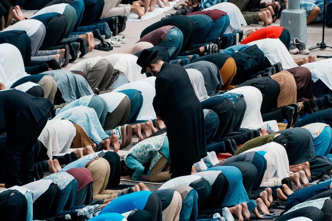 Community members bow in prayer during the funeral services Thursday.