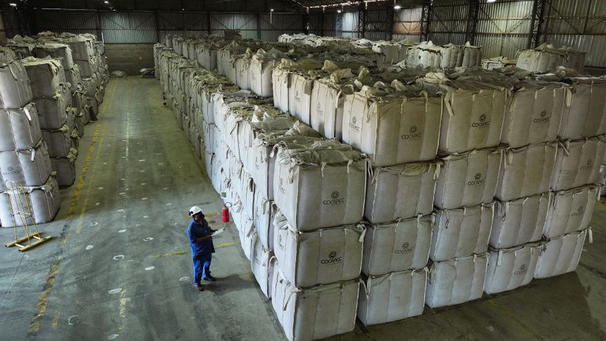 A worker checks sacks of coffee beans at a farmers' cooperative warehouse in Franca, Brazil, on August 1.