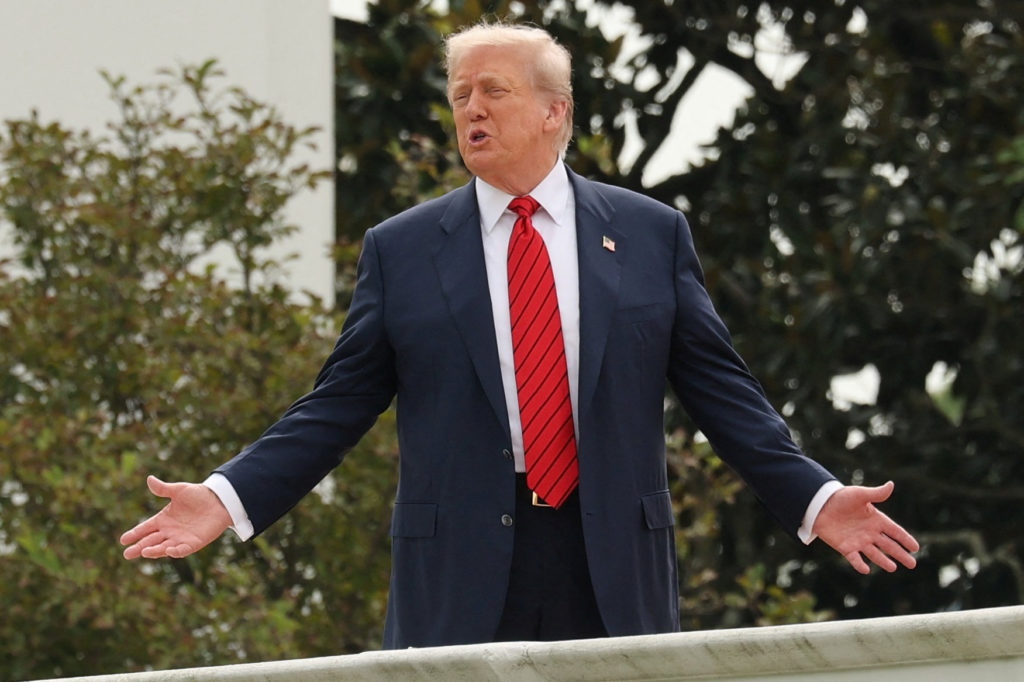 U.S. President Trump talks with architect McCrery as they walk on the roof of the White House in Washington