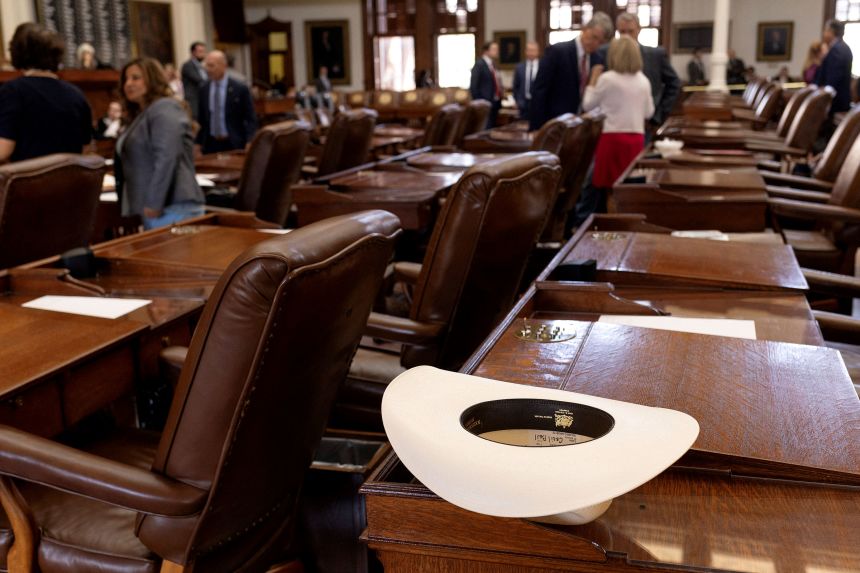 A cowboy hat belonging to Republican Rep. Cecil Bell of Magnolia, Texas, sits on his desk prior to the Texas State House coming to order on Tuesday.