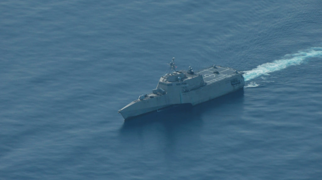 An aerial view of the USS Cincinnati combat ship navigates near the disputed Scarborough Shoal, as a Philippine Coast Guar...