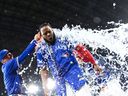 Vladimir Guerrero Jr. of the Toronto Blue Jays gets an ice bath from Myles Straw after their MLB game against the New York Yankees at Rogers Centre on Monday, June 30, 2025, in Toronto. 