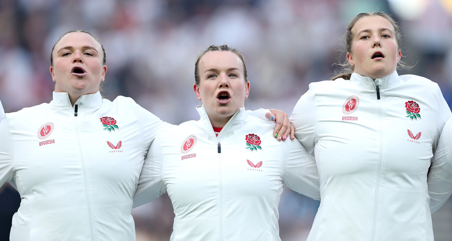 Lark Atkin-Davies, Sarah Bern and Morwenna Talling line up together to sing the national anthem at the women's rugby world cup opening game