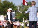 Brooke M. Henderson of Canada is sprayed with champagne on the 18th green after winning the CPKC Women's Open at Mississauga Golf and Country Club on Sunday, Aug. 24, 2025, in Mississauga, Ont.